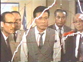 Dull-faced Korean guys stare at map.
